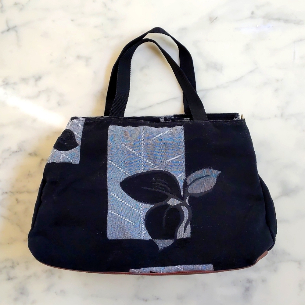 NWOT. Woman's corduroy bag with floral patchwork design.